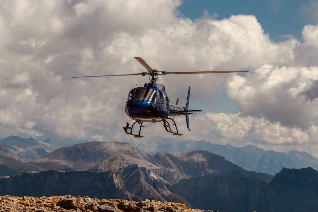 Rescue helicopter operating over Nepal mountain terrain